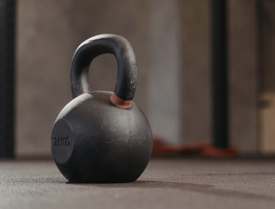 Single cast iron kettlebell on dark background