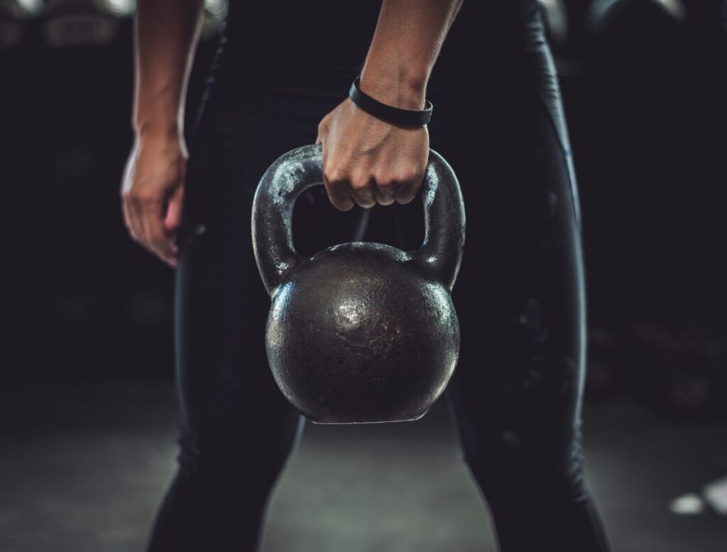person holding kettlebell strength training workout