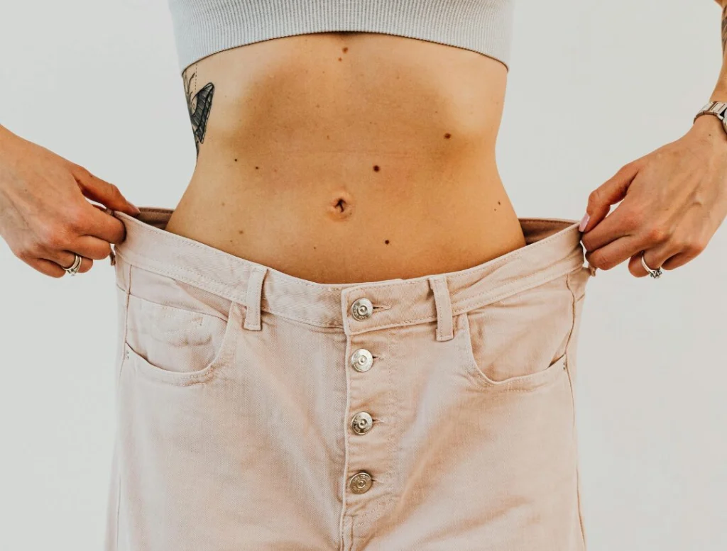 woman showing waist weight loss progress