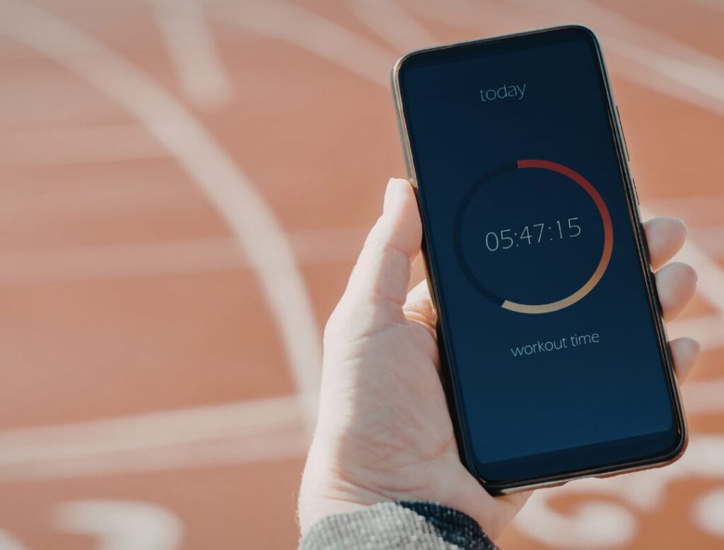 woman checking phone after workout