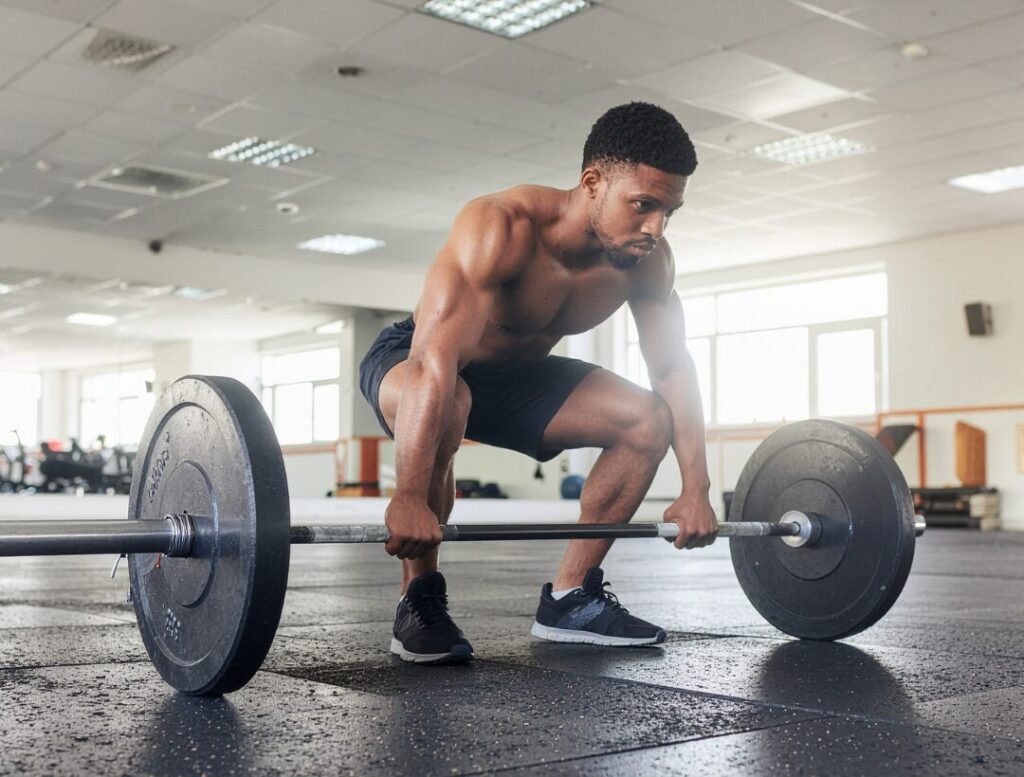 man performing barbell squat strength training