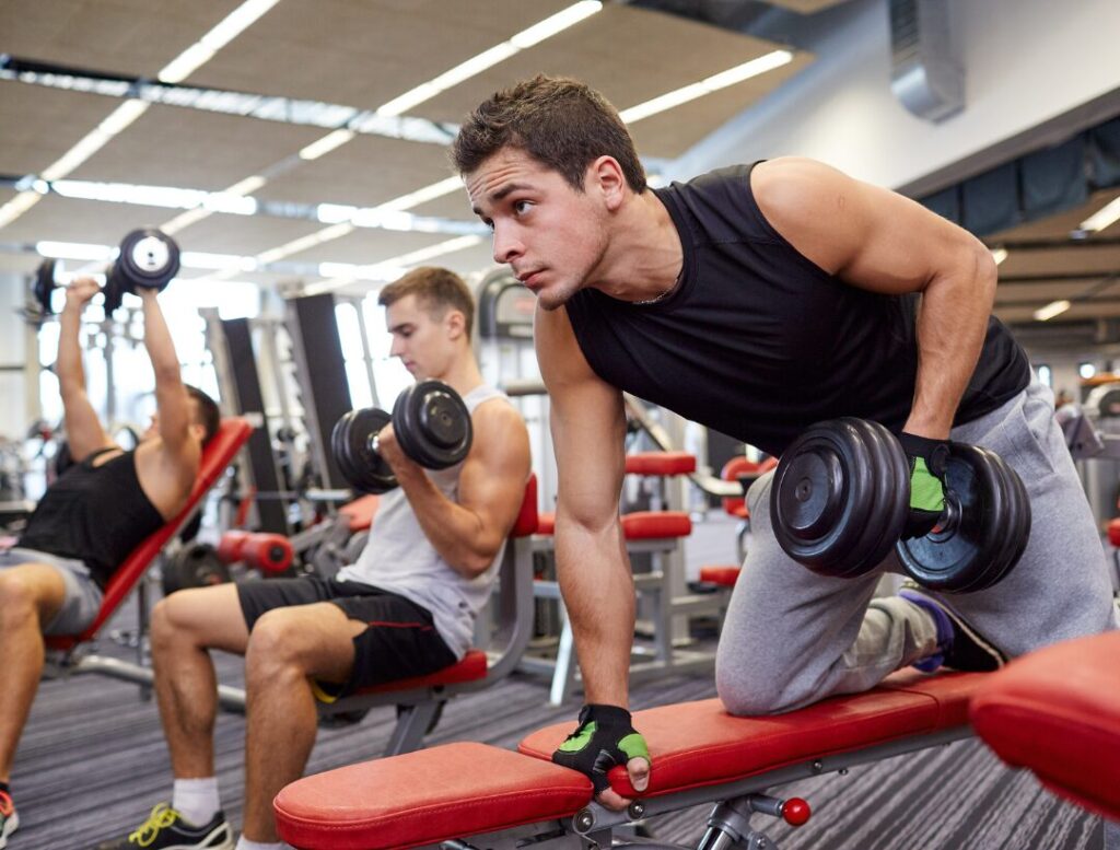 man doing dumbbell workout on bench