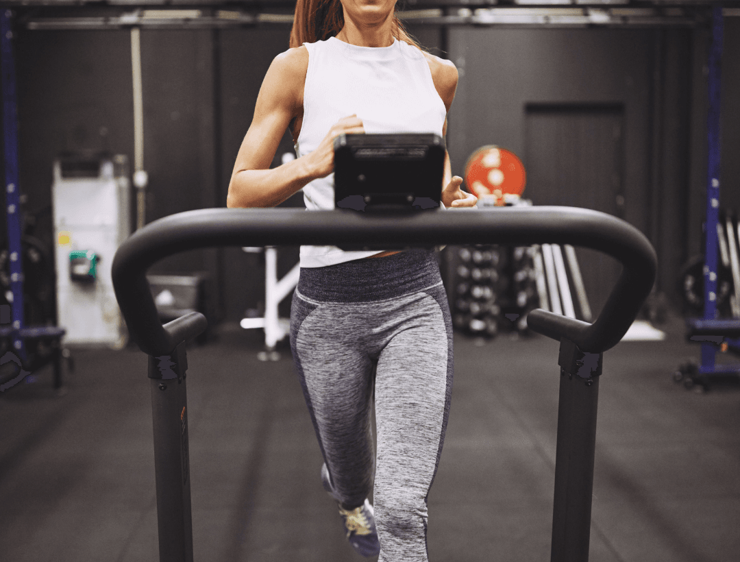 woman running on a curved treadmill